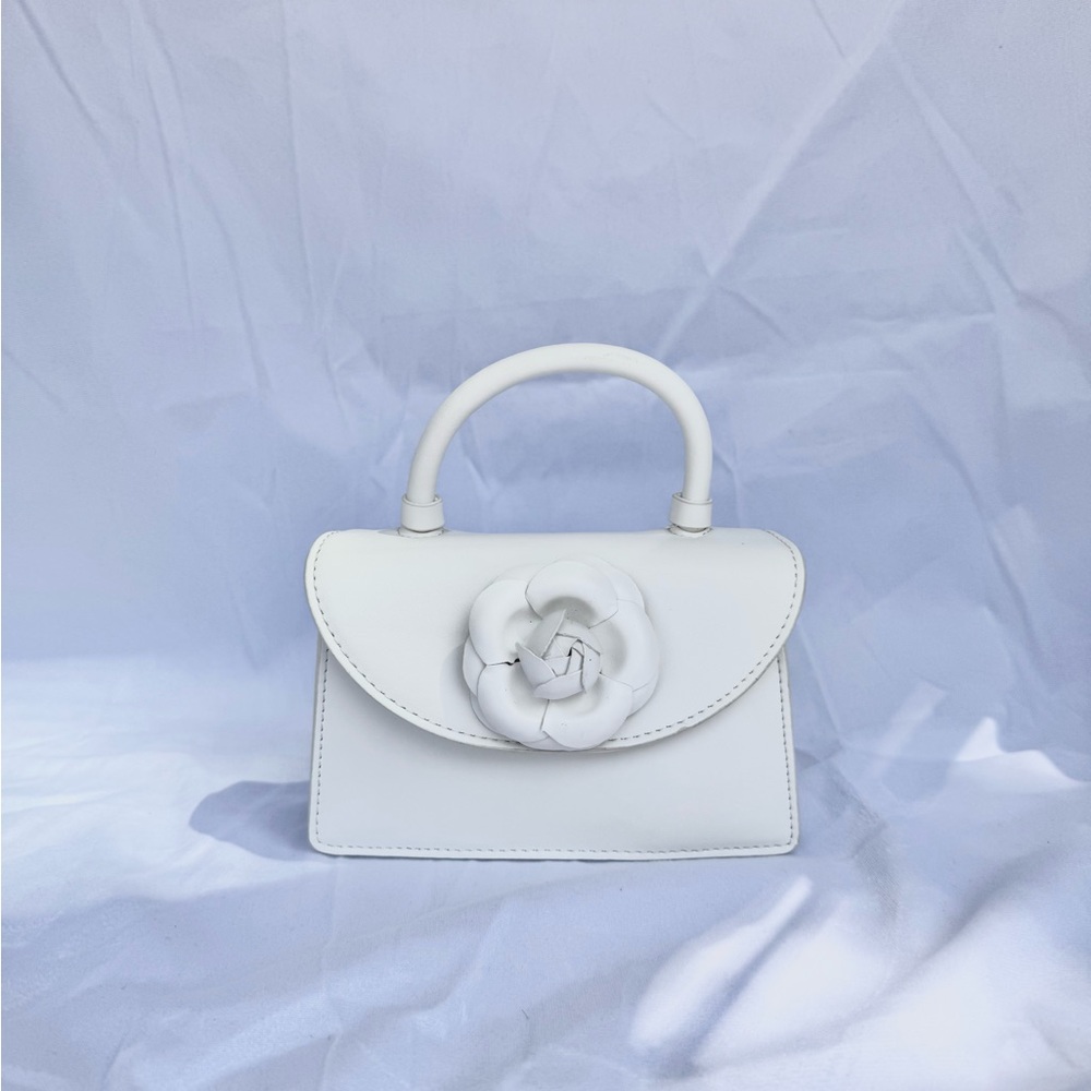 Elegant White Handbag with Floral Accent